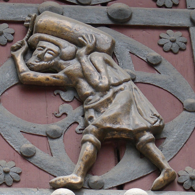 Een Bastaixo die steen sjouwt voor de bouw van de Santa Maria del Mar kerk