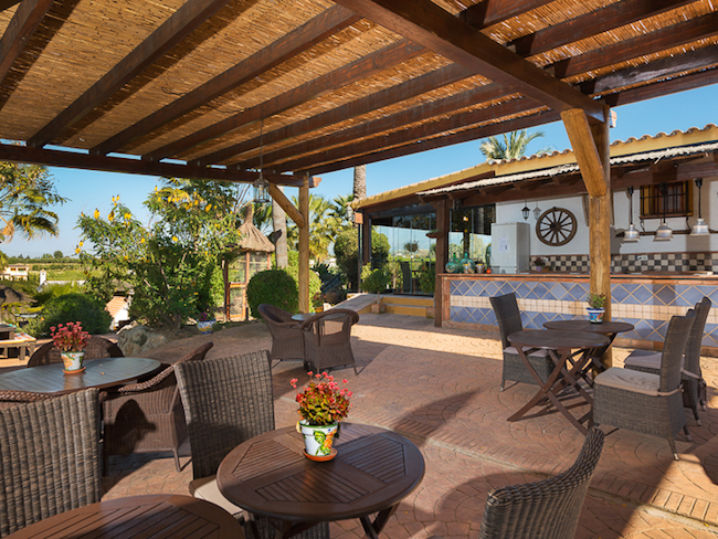 Het terras en restaurant van het kleine vakantiepark in het binnenland van Malaga